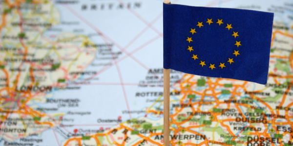 EU flag pinned onto a map of Europe